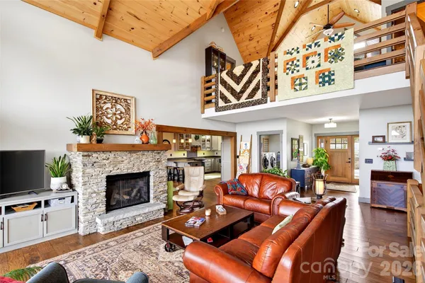 a living room with furniture a rug and white walls