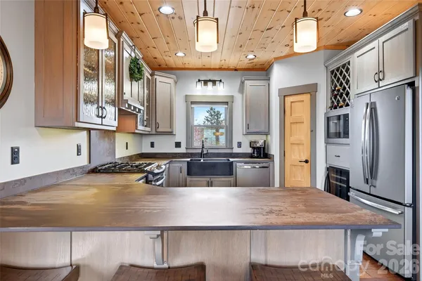 a kitchen with stainless steel appliances a refrigerator and a stove top oven