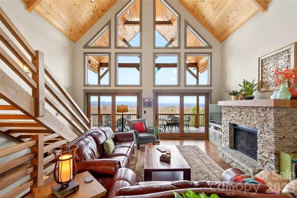 a living room with furniture fireplace and a large window