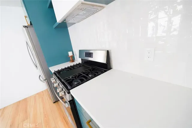 a kitchen with a stove and a refrigerator