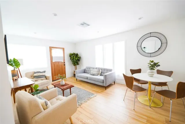 a living room with furniture a fireplace and a potted plant