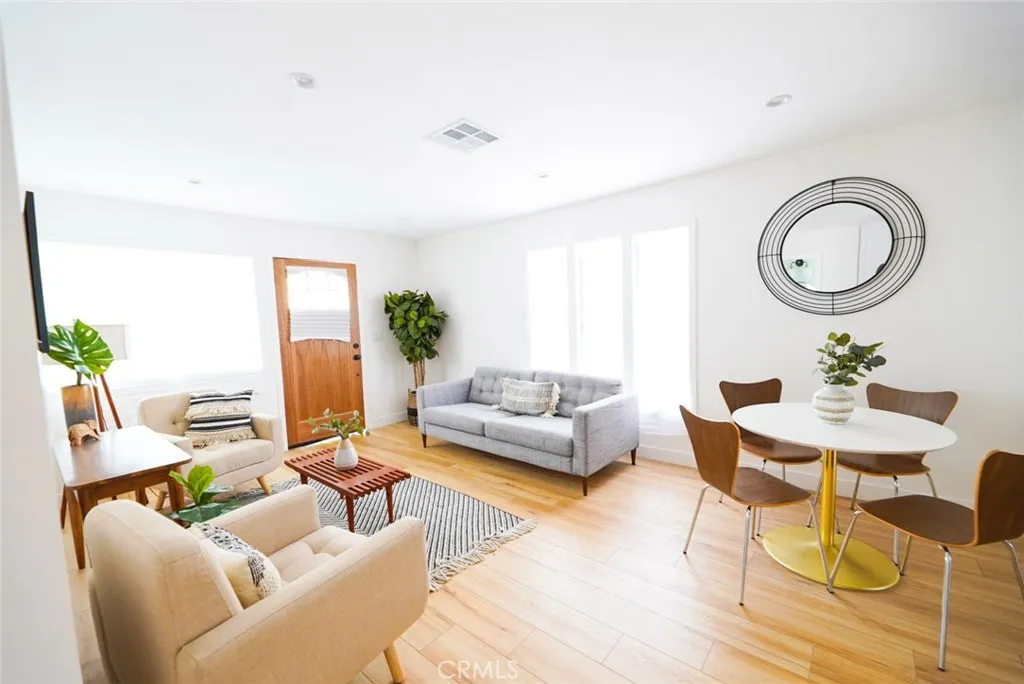 3642 6th Avenue Jefferson Park, CA 90018 - Photo 6 of 26 a living room with furniture a fireplace and a potted plant