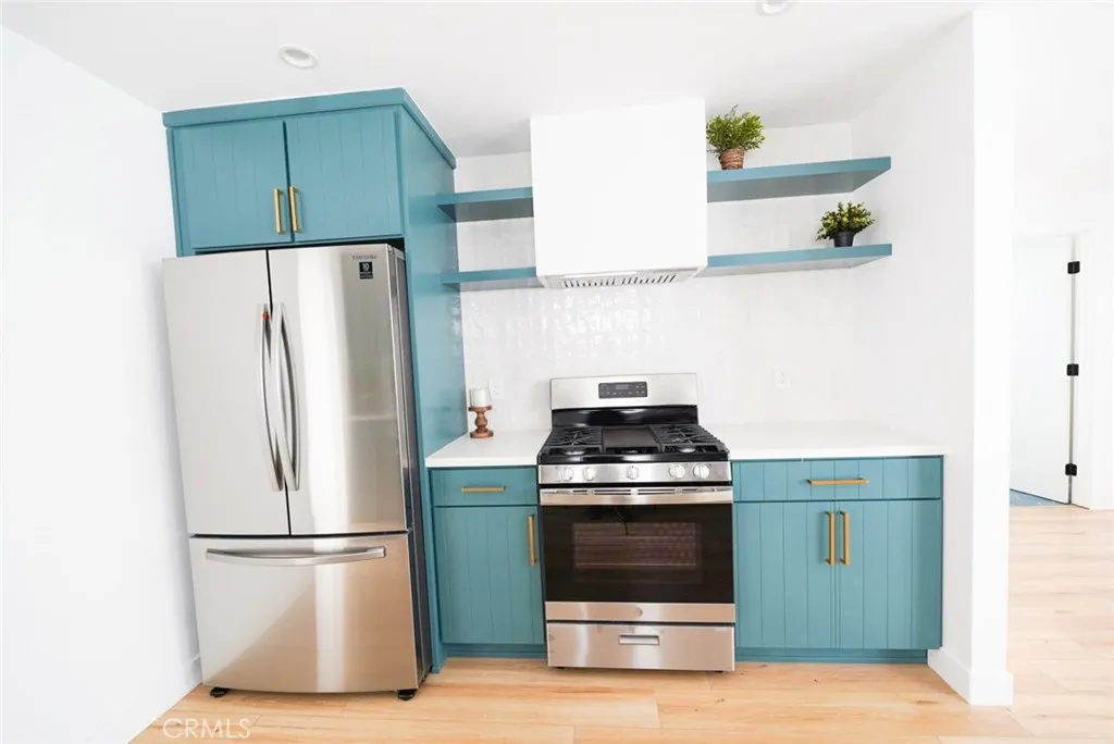 3642 6th Avenue Jefferson Park, CA 90018 - Photo 10 of 26 a kitchen with a stove and a refrigerator