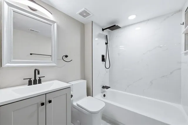 a bathroom with a sink a toilet and a bathtub