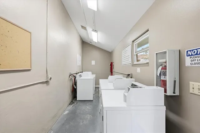 a view of a hallway to a room with wooden floor