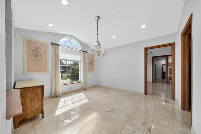 a view of spacious bedroom with a chandelier