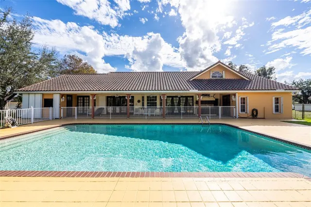 a view of a porch with wooden floor and iron stairs