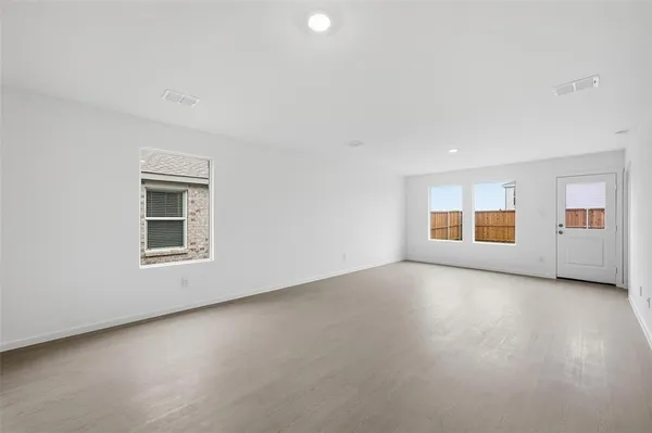 an empty room with a empty space and windows