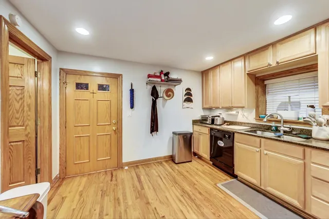 a kitchen with stainless steel appliances granite countertop a refrigerator and a sink