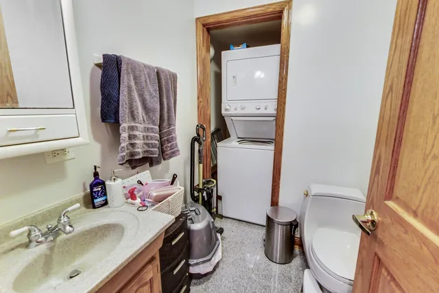 a bathroom with a sink toilet and mirror