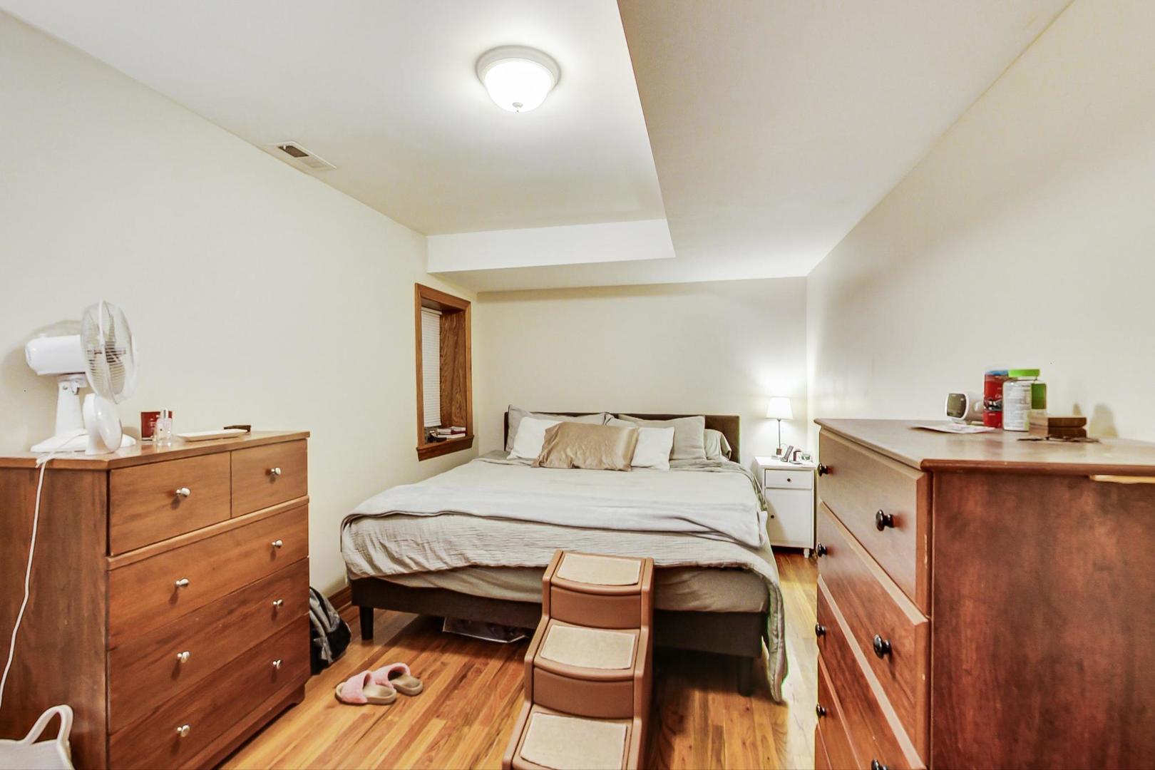 2911 North Talman Avenue, Unit 1 Chicago, IL 60618 - Photo 14 of 21 a bedroom with a bed and a table in it