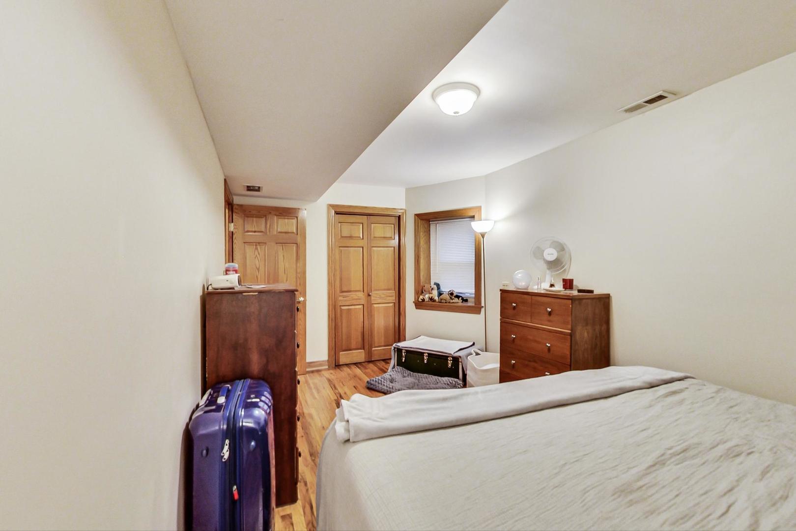 2911 North Talman Avenue, Unit 1 Chicago, IL 60618 - Photo 15 of 21 a bedroom with a bed and a closet