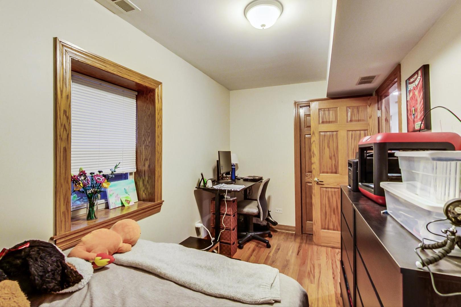 2911 North Talman Avenue, Unit 1 Chicago, IL 60618 - Photo 17 of 21 a living room with furniture a flat screen tv and a dining table