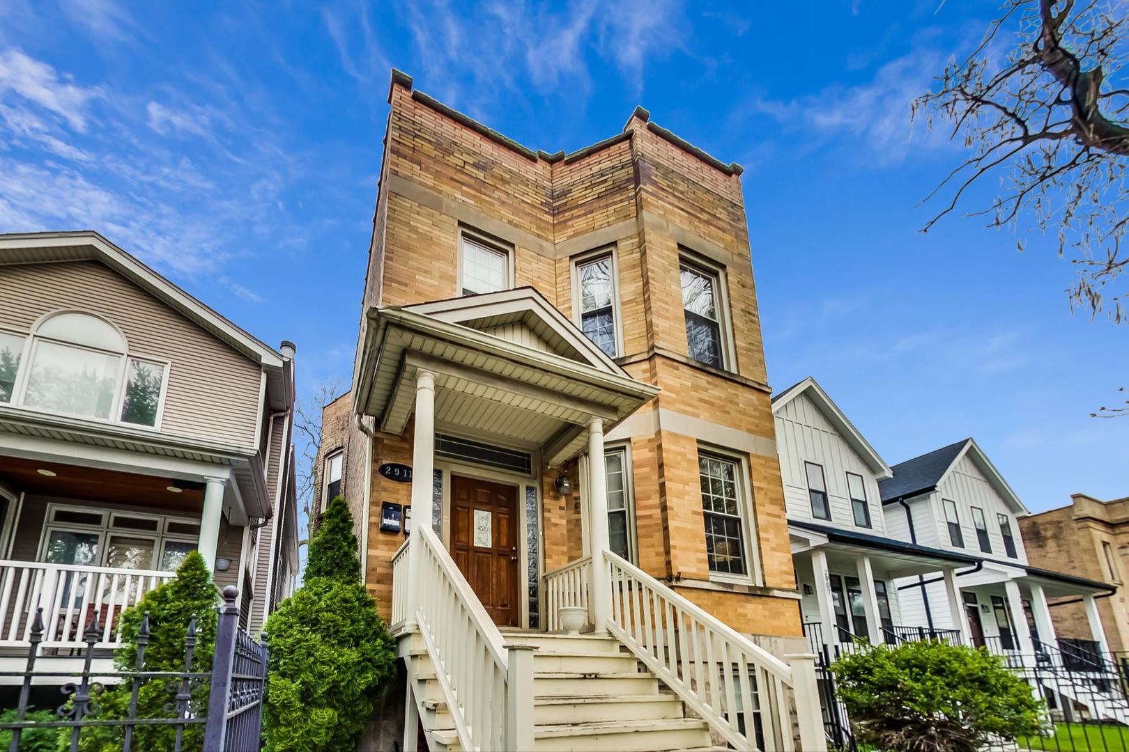 2911 North Talman Avenue, Unit 1 Chicago, IL 60618 - Photo 20 of 21 front view of a house with a small yard