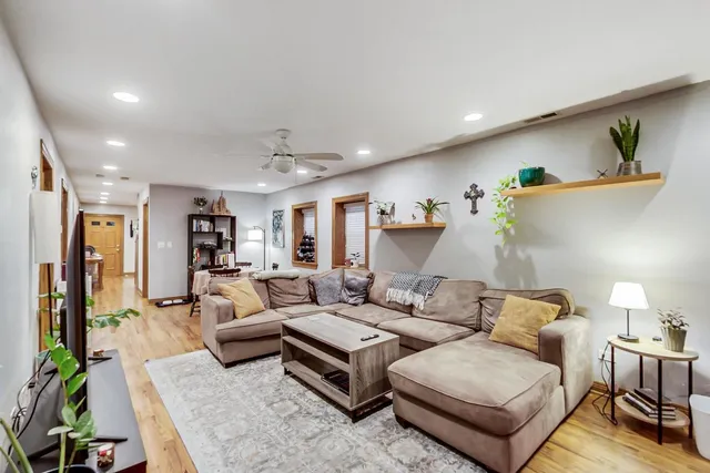 a living room with furniture and a lamp