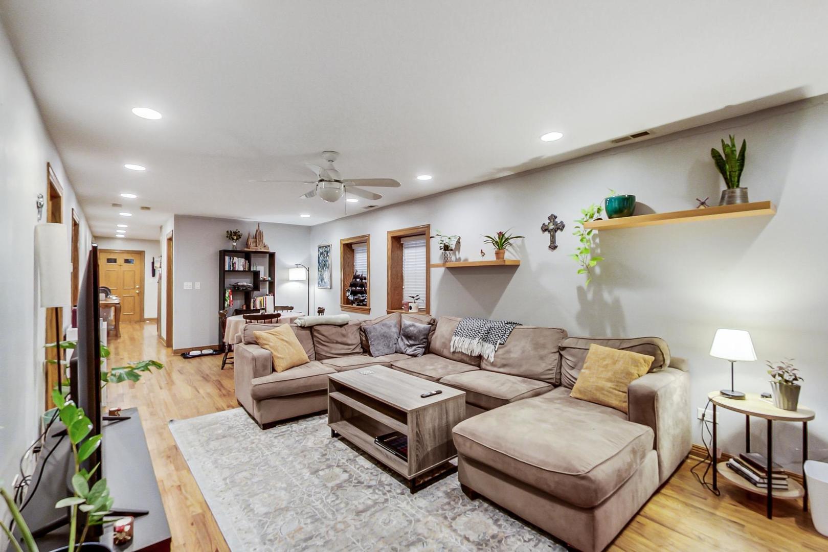 2911 North Talman Avenue, Unit 1 Chicago, IL 60618 - Photo 3 of 21 a living room with furniture and a lamp