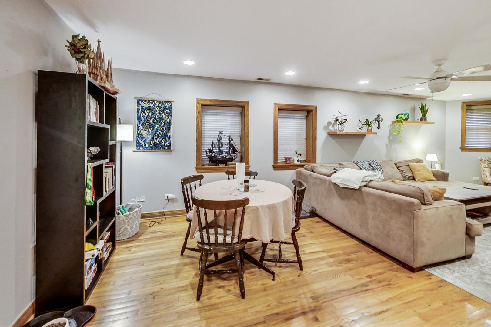2911 North Talman Avenue, Unit 1 Chicago, IL 60618 - Photo 6 of 21 a living room with furniture and a book shelf