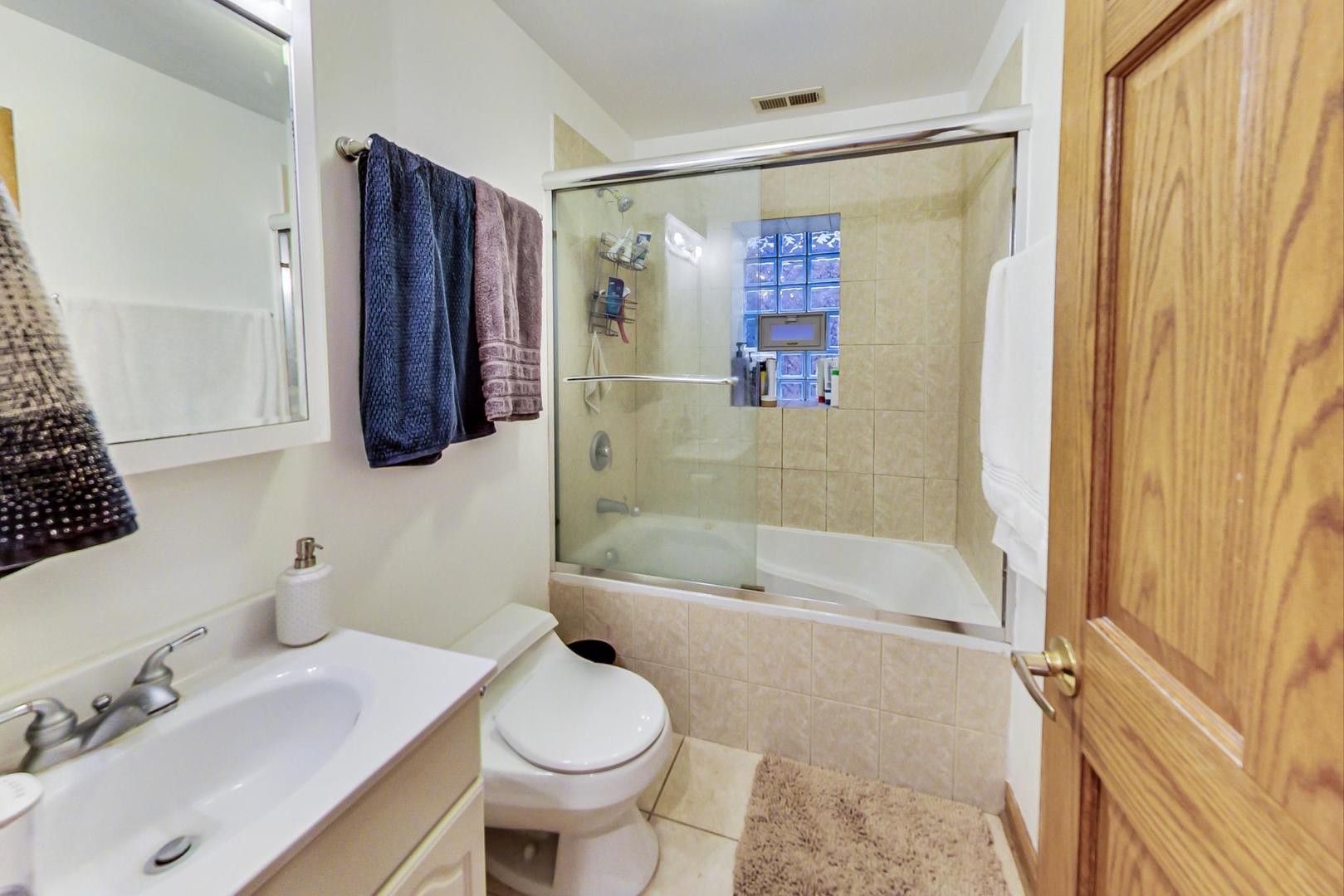 2911 North Talman Avenue, Unit 1 Chicago, IL 60618 - Photo 9 of 21 a bathroom with a sink toilet and shower
