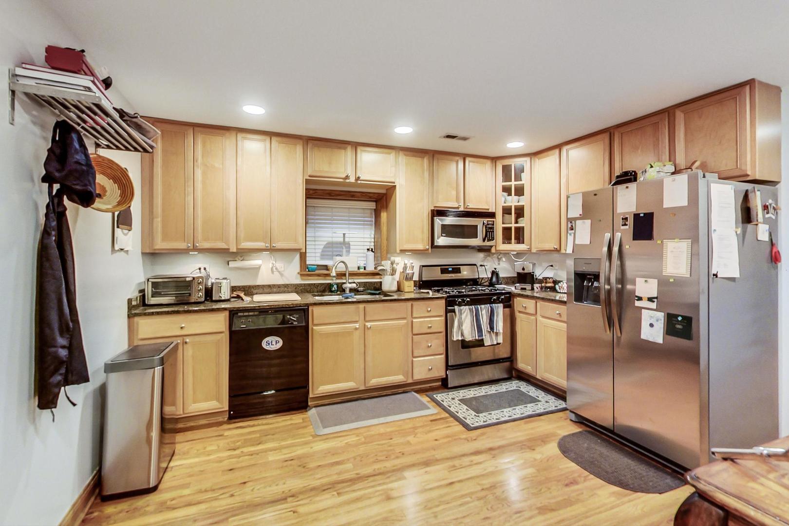 2911 North Talman Avenue, Unit 1 Chicago, IL 60618 - Photo 10 of 21 a kitchen with granite countertop a refrigerator stove top oven and sink