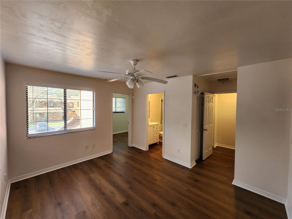 5823 Southwest 9th Place, Unit H55 Gainesville, FL 32607 - Photo 37 of 50 an empty room with wooden floor and windows
