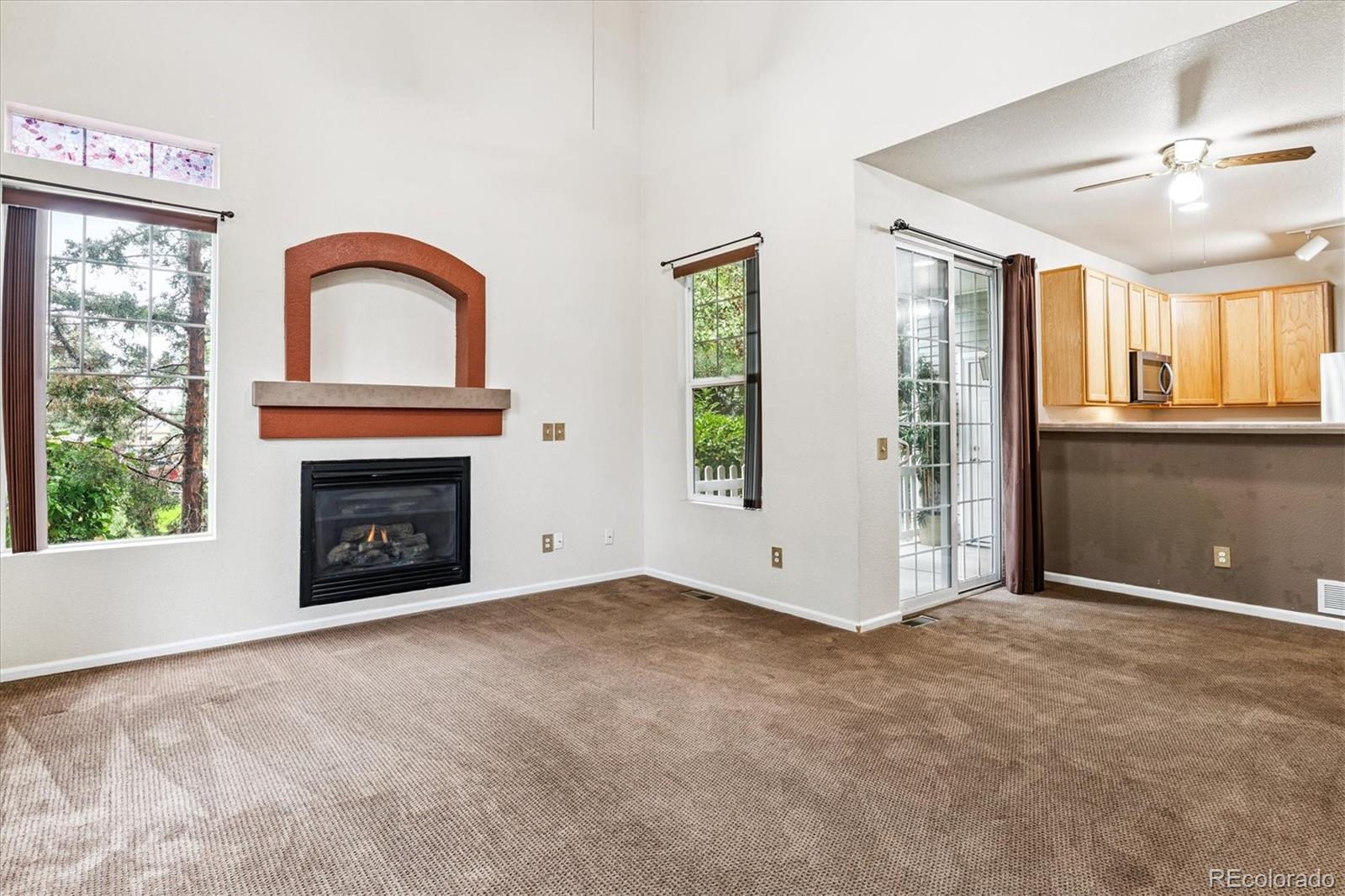 4658 Flower Street Wheat Ridge, CO 80033 - Photo 12 of 26 a view of an empty room with a fireplace and a window