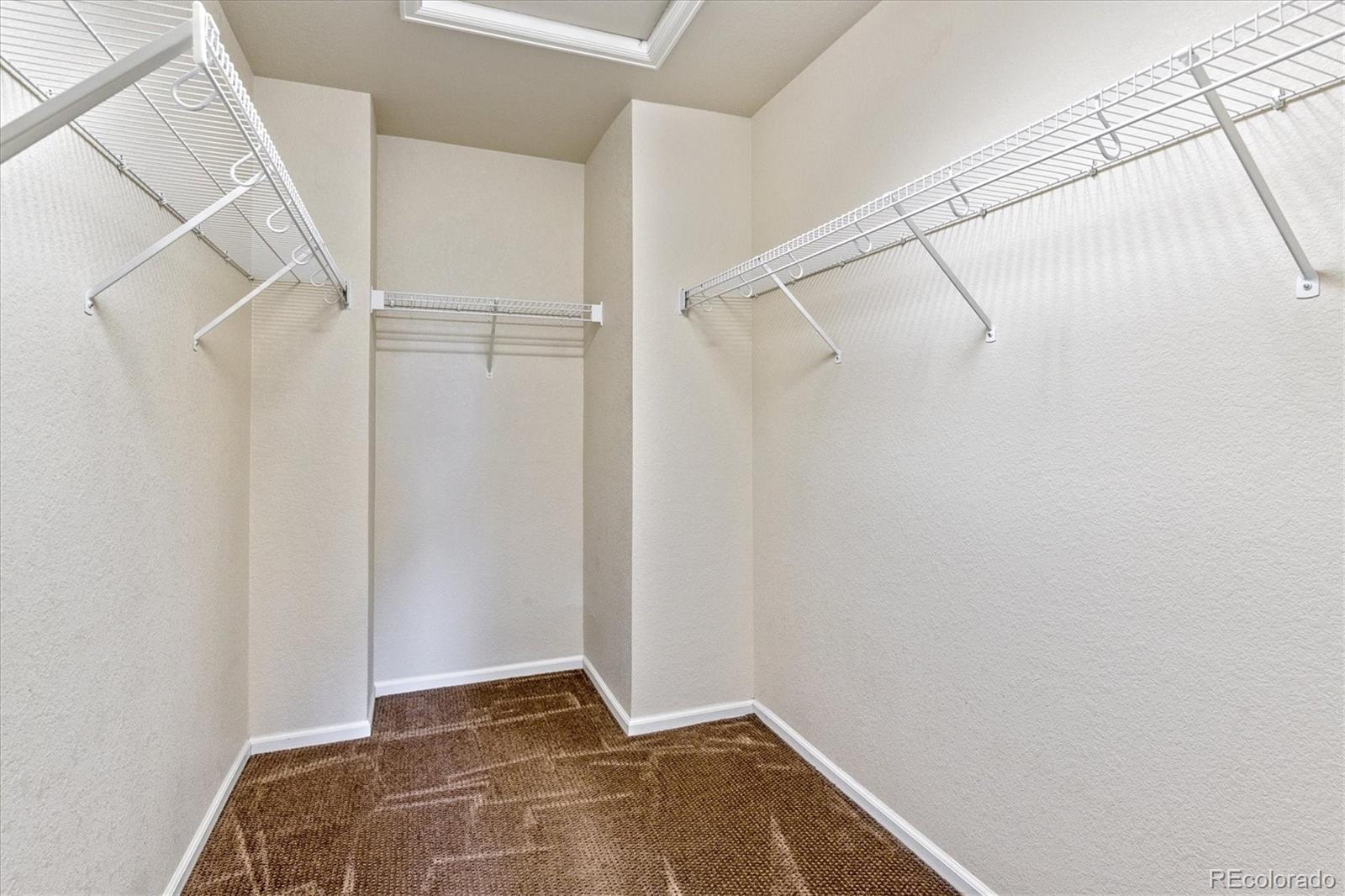 4658 Flower Street Wheat Ridge, CO 80033 - Photo 20 of 26 a view of walk in closet with empty racks