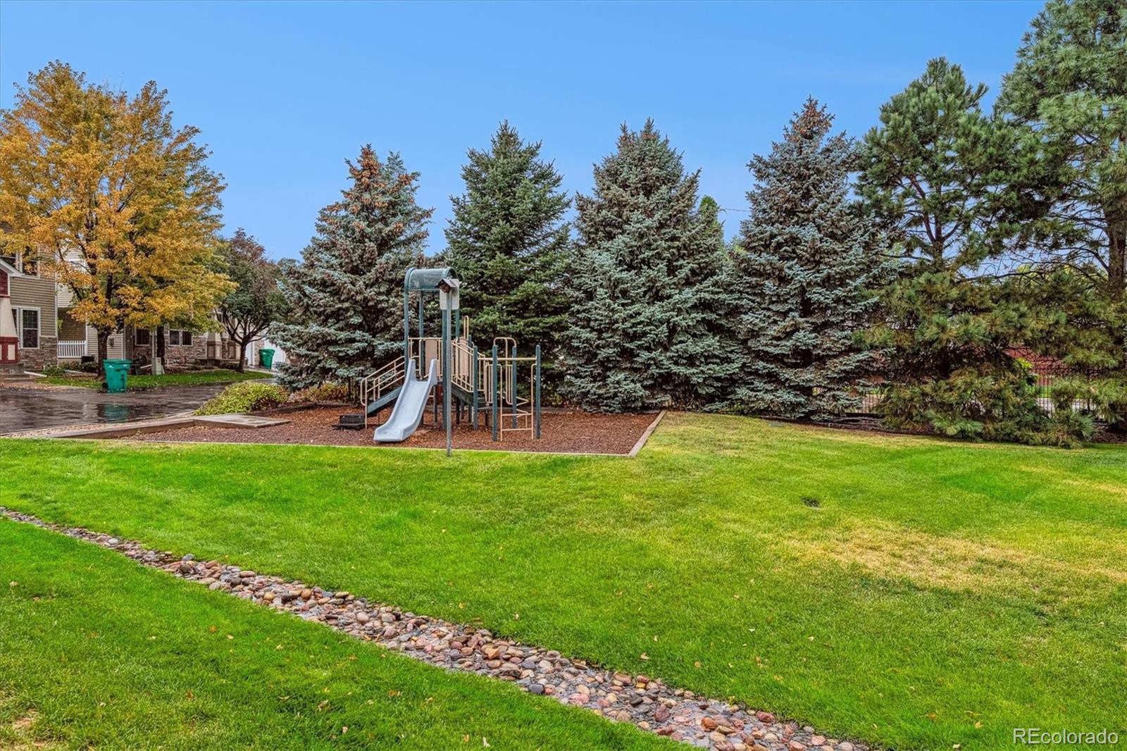 4658 Flower Street Wheat Ridge, CO 80033 - Photo 26 of 26 a view of a park with swings and slides