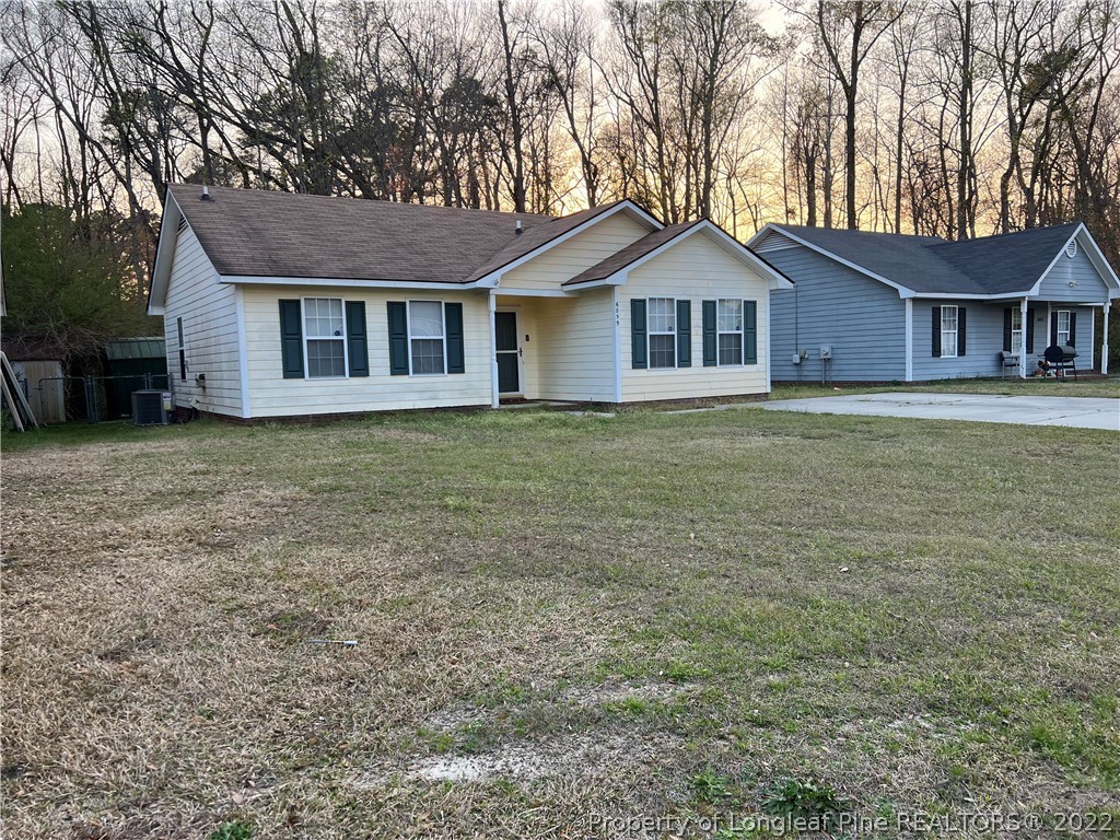 6859 Bailey Lake Road Fayetteville, NC 28304 - Photo 1 of 15 a front view of a house with garden
