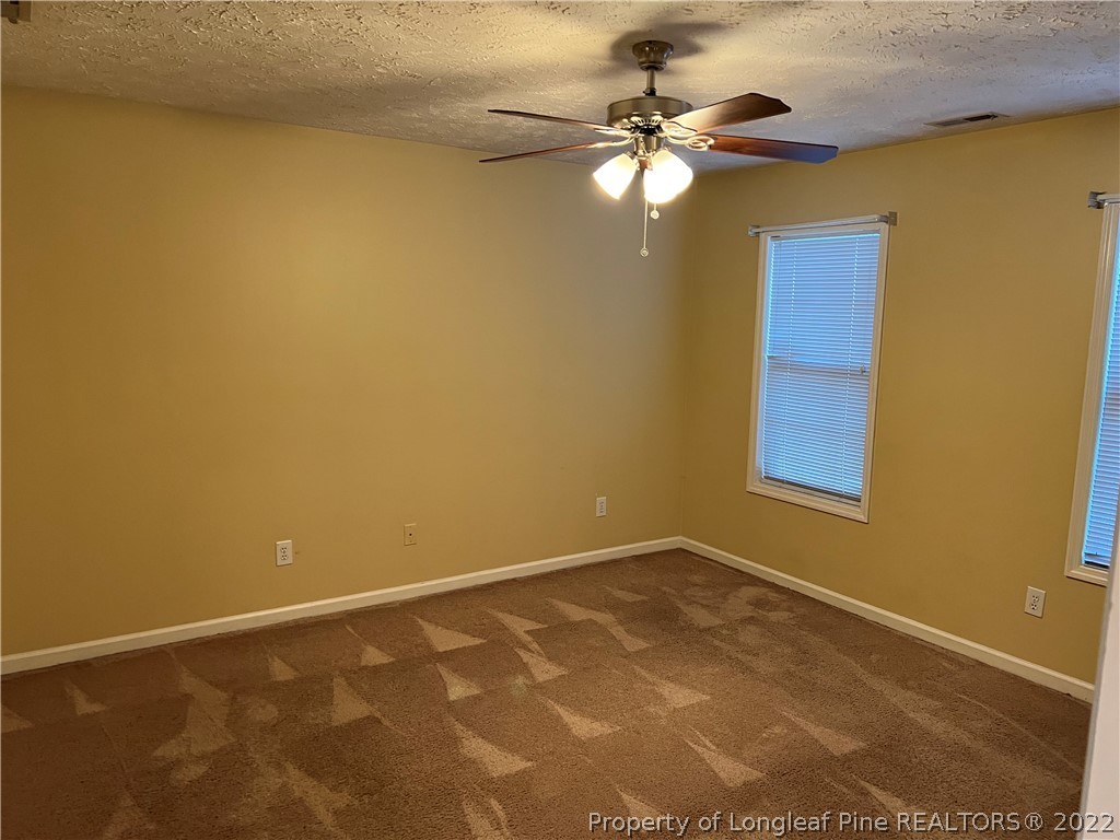 6859 Bailey Lake Road Fayetteville, NC 28304 - Photo 8 of 15 a view of a room with a ceiling fan and a window