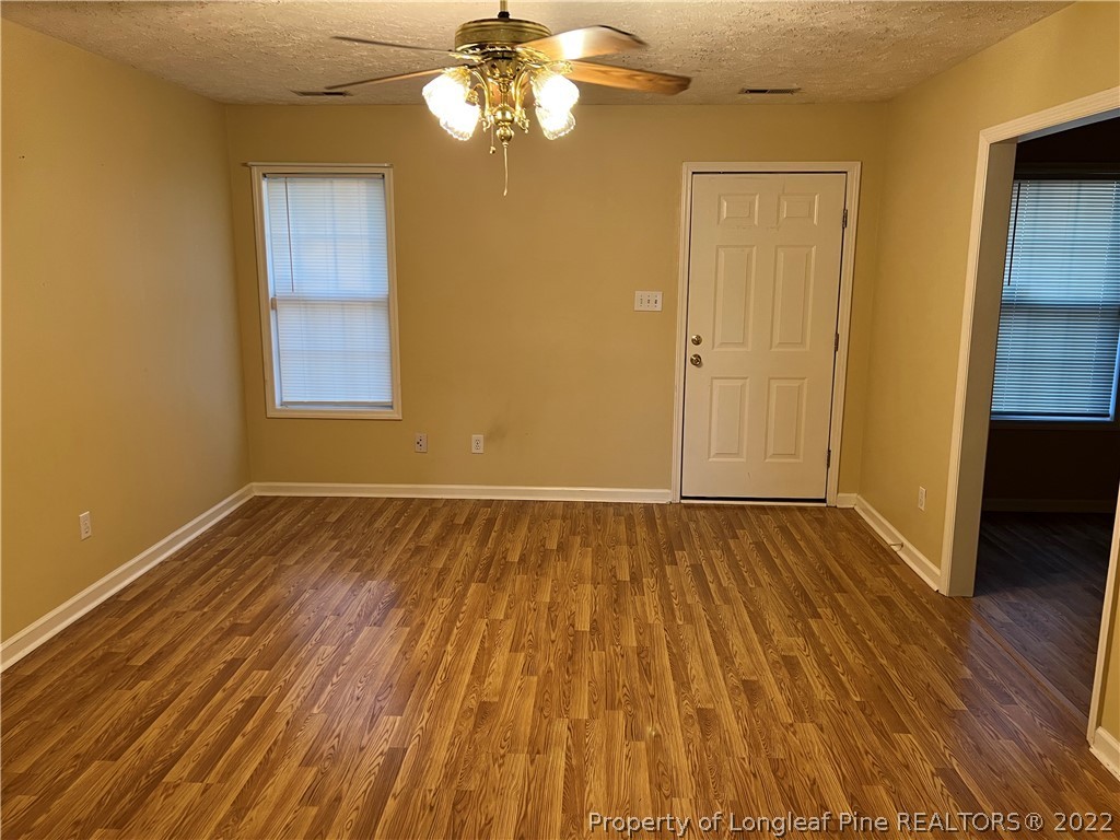 6859 Bailey Lake Road Fayetteville, NC 28304 - Photo 9 of 15 wooden floor in an empty room with a window