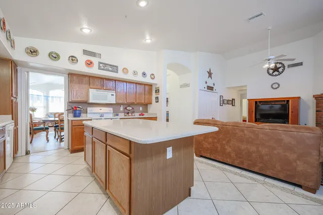 a kitchen with stainless steel appliances a stove top oven a sink a counter top space and cabinets
