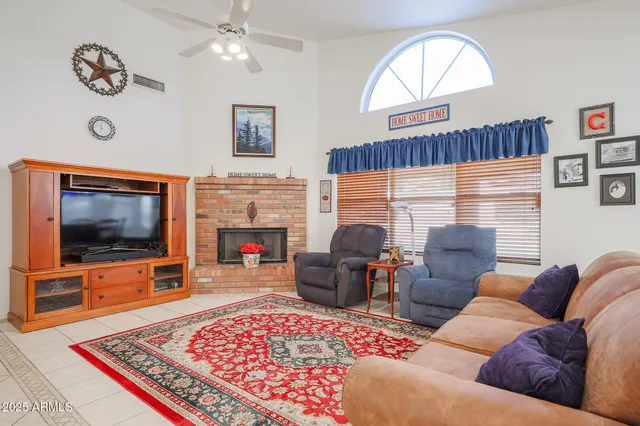 a living room with furniture a flat screen tv and a fireplace