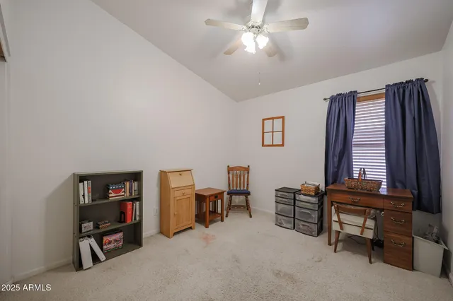 a view of a livingroom with furniture and a bookshelf