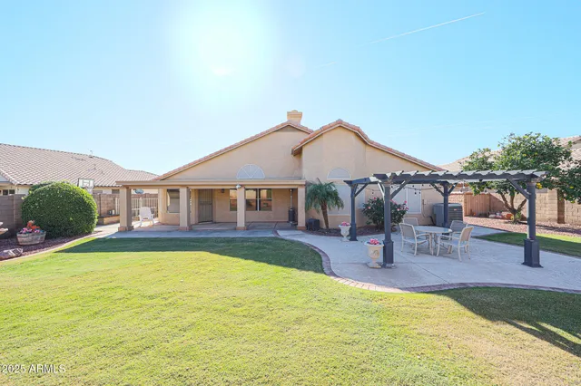 a view of a house with swimming pool and sitting area