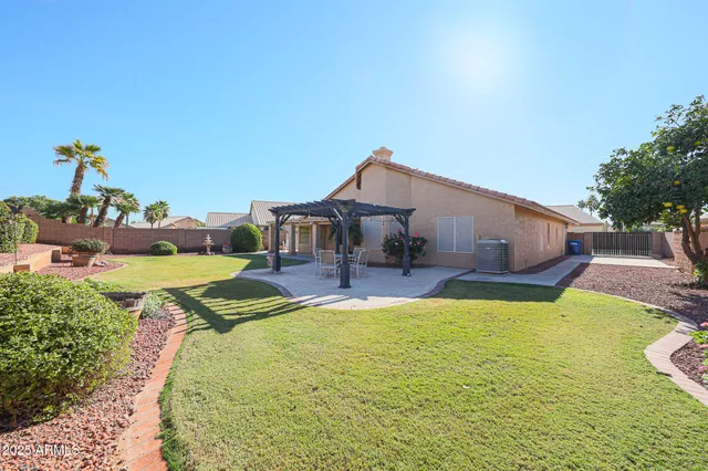 a swimming pool with yard and outdoor seating