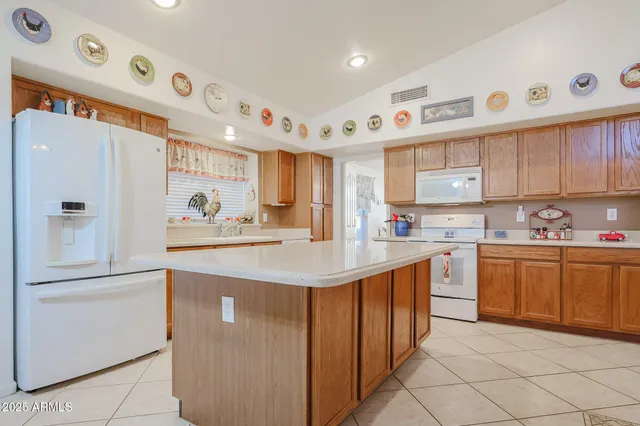 a kitchen with granite countertop a sink and white stainless steel appliances