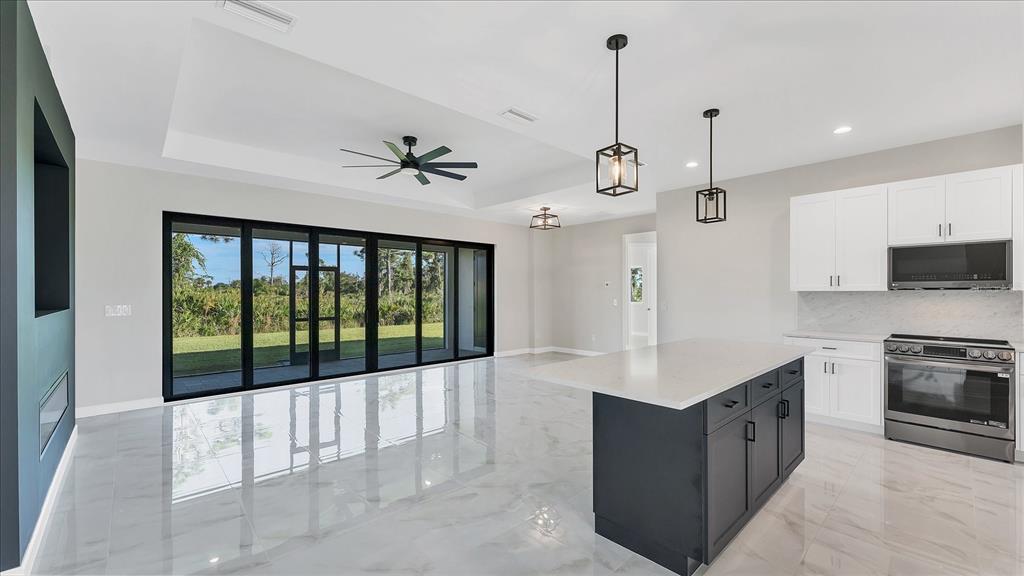 242 Brig Circle West Placida, FL 33946 - Photo 12 of 30 a large kitchen with a large window and stainless steel appliances