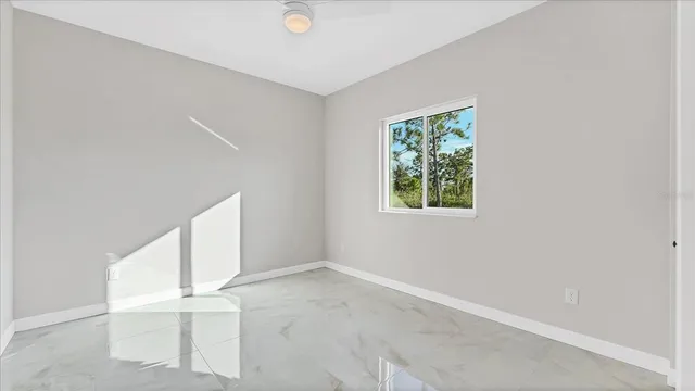 an empty room with windows and closet