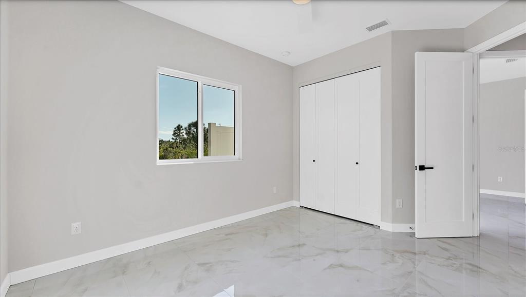 242 Brig Circle West Placida, FL 33946 - Photo 21 of 30 an empty room with windows and closet
