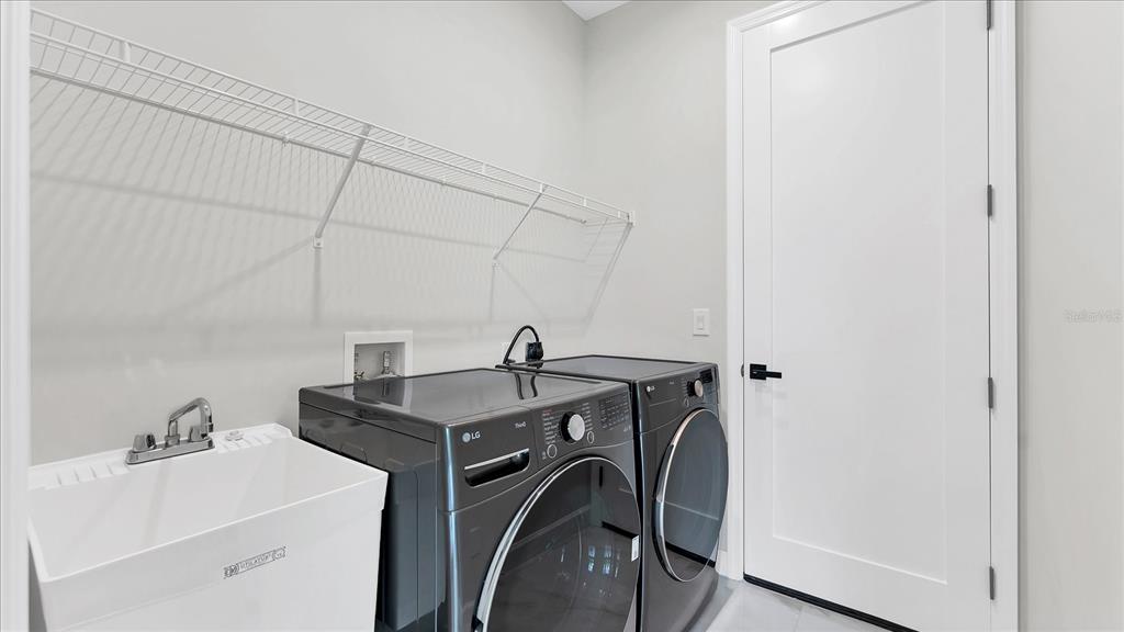 242 Brig Circle West Placida, FL 33946 - Photo 26 of 30 a view of a storage and utility room with washer and dryer