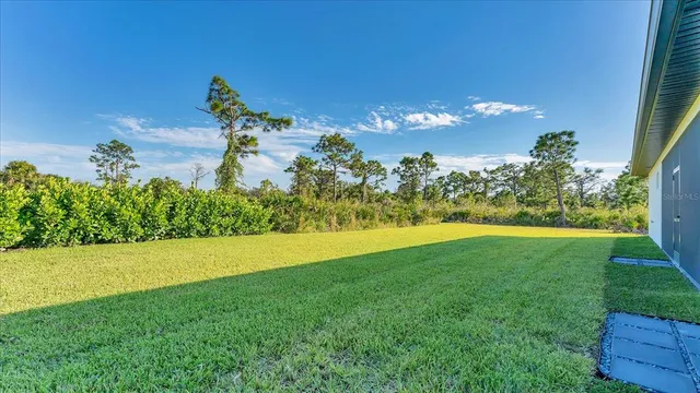 a view of a house with backyard and garden