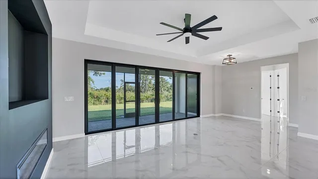a view of a livingroom with a ceiling fan and window