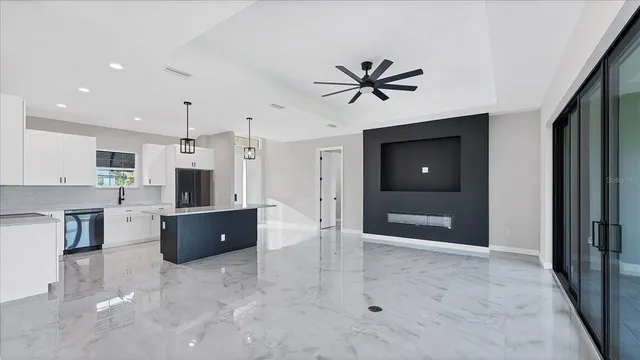 a view of a kitchen with a sink and a refrigerator