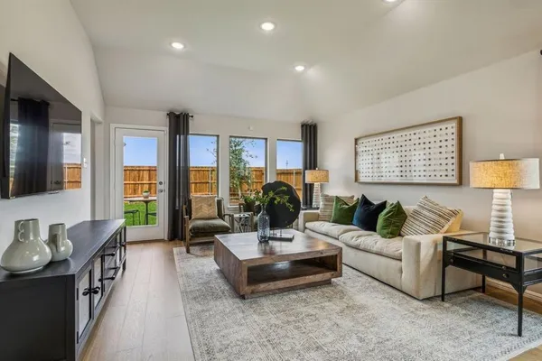a living room with furniture and wooden floor