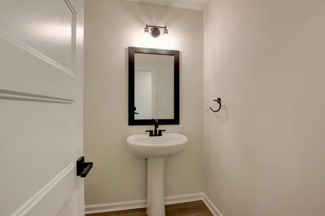 a bathroom with a sink a mirror and vanity
