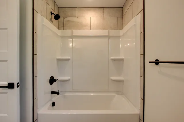 a bathroom with a bathtub and a shower