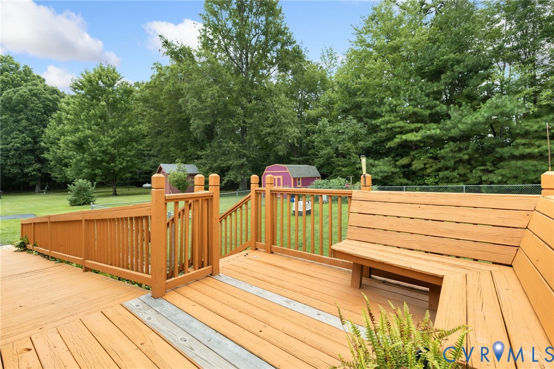 2570 Sandy Lane Victoria, VA 23974 - Photo 30 of 37 Wooden terrace featuring a shed, view of wooded ar