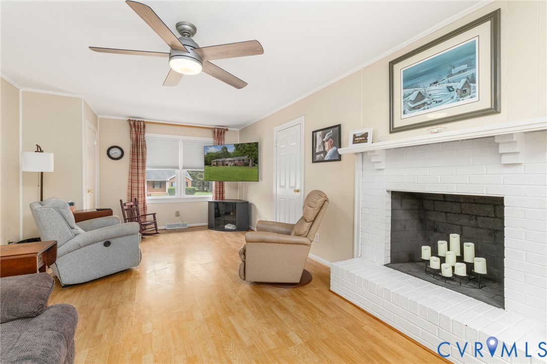 2570 Sandy Lane Victoria, VA 23974 - Photo 8 of 37 Living area with crown molding, a fireplace, wood