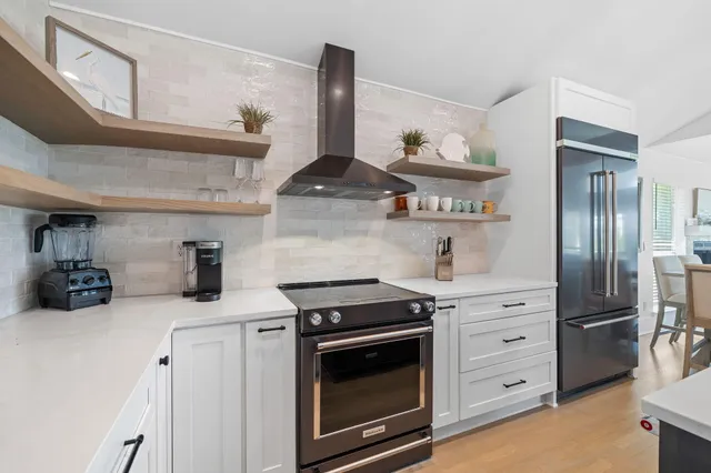 a kitchen with stainless steel appliances a stove and cabinets