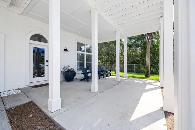 a living room with furniture and large windows
